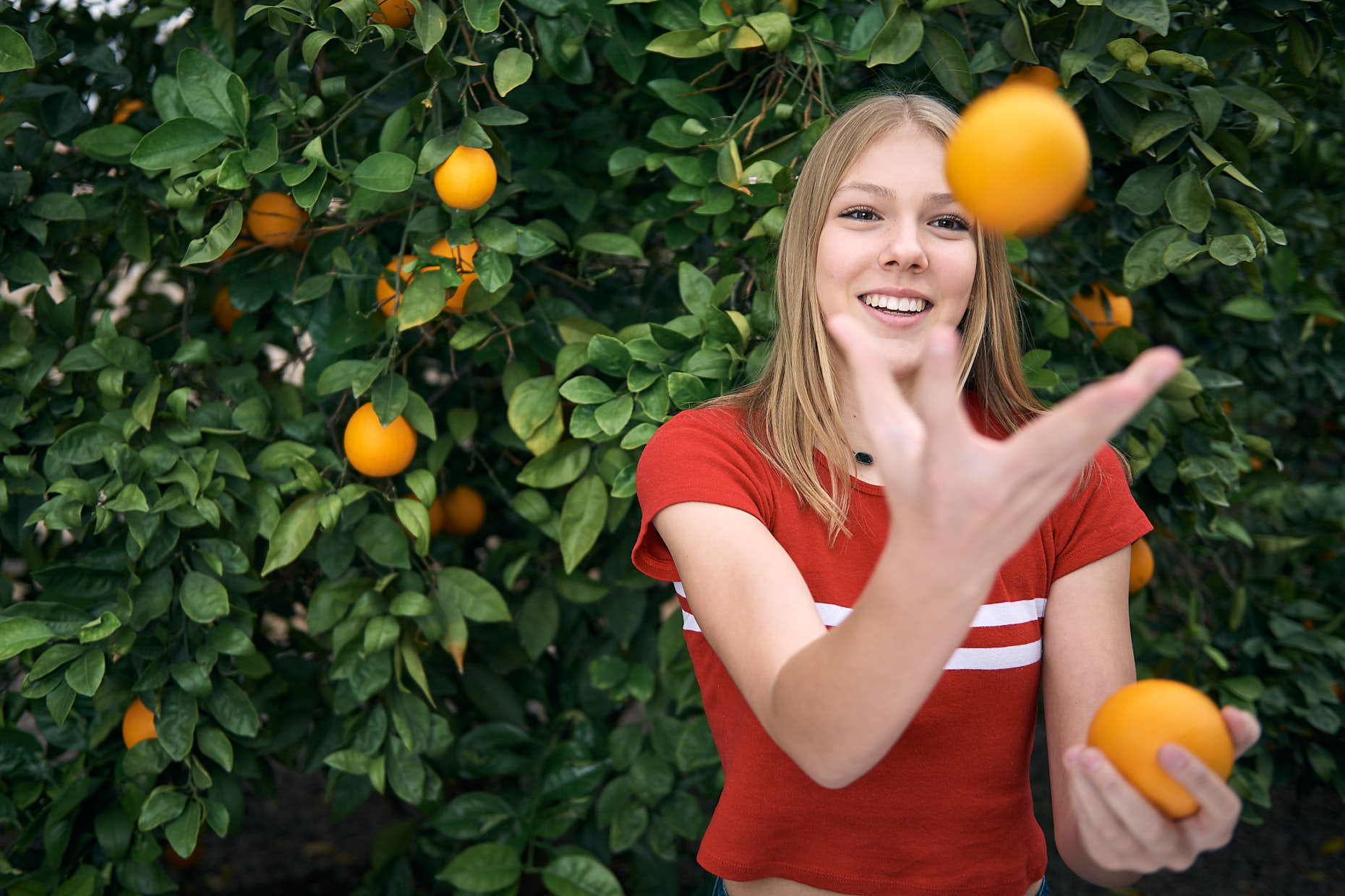 Jason Tracy - Advertising Photographer Kansas City - Young Girl with Orange Tree